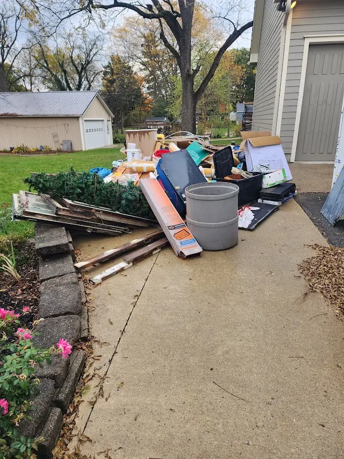 Dumpster being loaded with debris for Estate Cleanout Dumpster Rental in Ridgefield